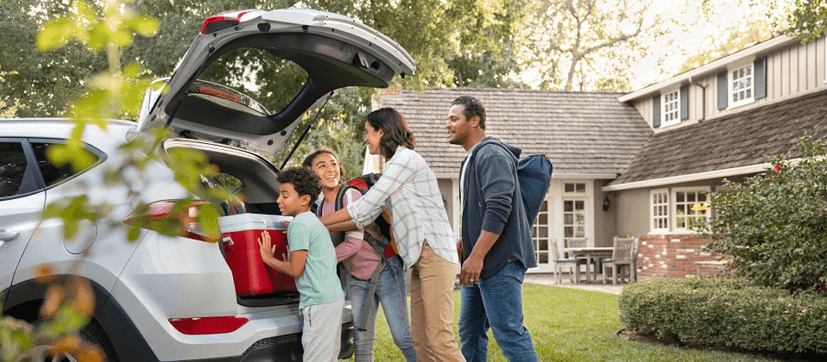 Family packing their car up to go camping