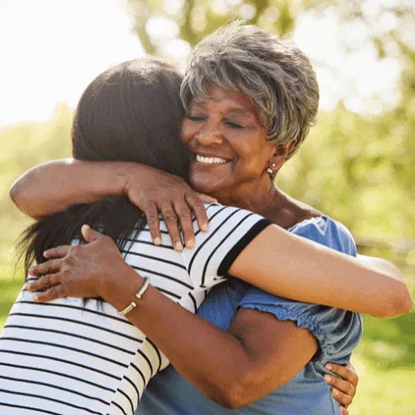 Image of a woman embracing her family after recovering pain and suffering damages, illustrating emotional relief post-accident.